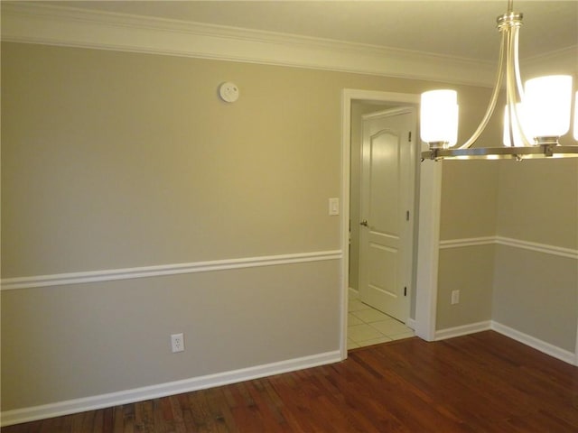 unfurnished dining area with ornamental molding and hardwood / wood-style floors