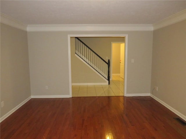 unfurnished room featuring hardwood / wood-style flooring and crown molding