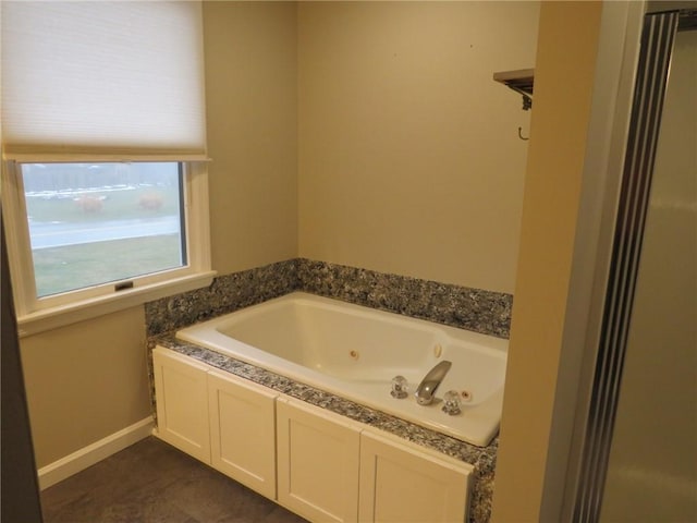 bathroom with tile patterned flooring and a washtub