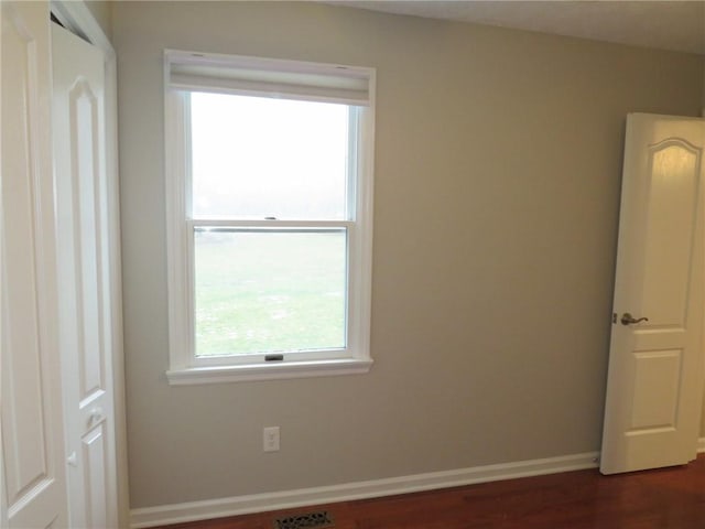 spare room featuring dark hardwood / wood-style flooring