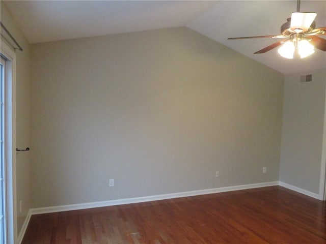 spare room featuring dark hardwood / wood-style flooring, lofted ceiling, and ceiling fan