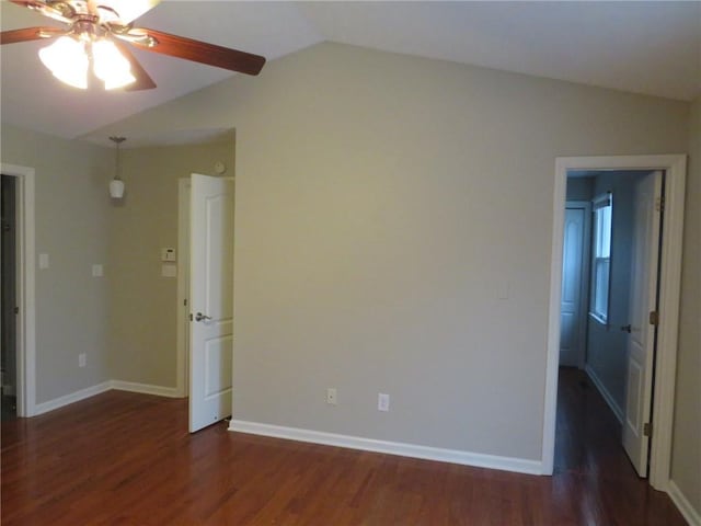 unfurnished room featuring dark wood-type flooring, ceiling fan, and lofted ceiling