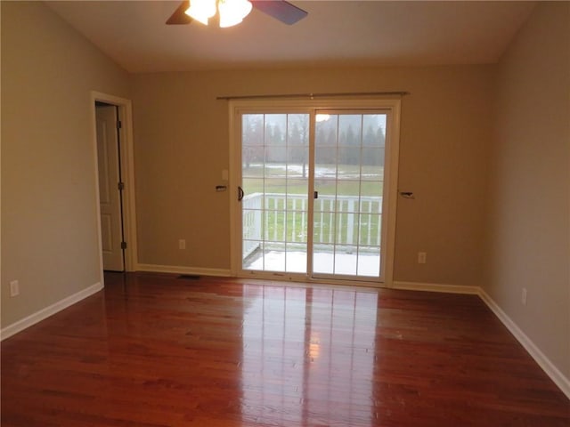 spare room featuring vaulted ceiling, dark hardwood / wood-style floors, and ceiling fan