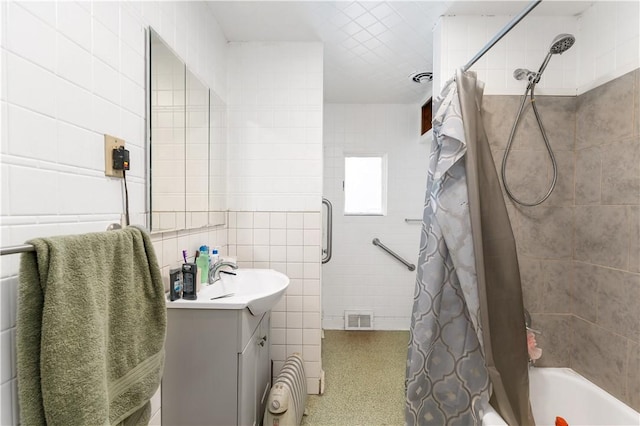 bathroom featuring shower / tub combo with curtain, vanity, and tile walls