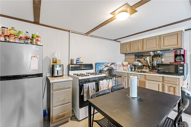 kitchen with tasteful backsplash, white range with gas cooktop, stainless steel fridge, and light brown cabinetry