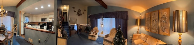 interior space featuring stove, vaulted ceiling with beams, and white cabinetry