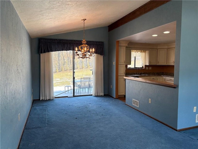 interior space with a chandelier, visible vents, vaulted ceiling, and light carpet