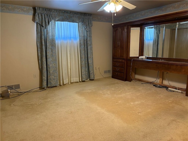 interior space featuring light carpet, ceiling fan, and visible vents