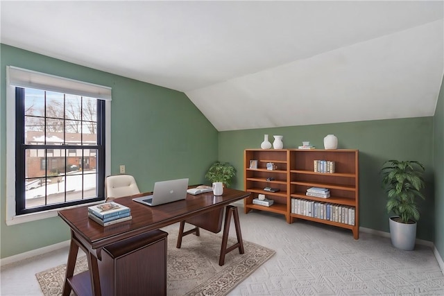 office area featuring vaulted ceiling and light carpet