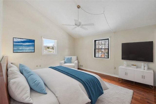 bedroom with vaulted ceiling, ceiling fan, and dark hardwood / wood-style flooring