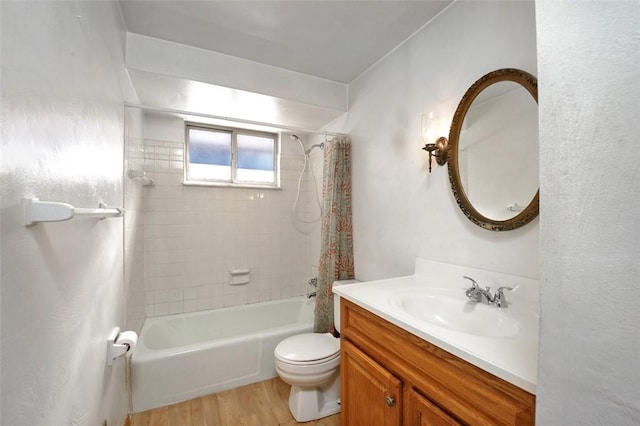 full bathroom featuring hardwood / wood-style flooring, vanity, toilet, and tiled shower / bath combo