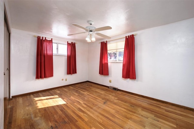 empty room with ceiling fan and hardwood / wood-style floors