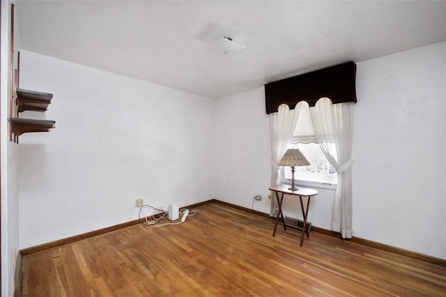 empty room featuring wood-type flooring