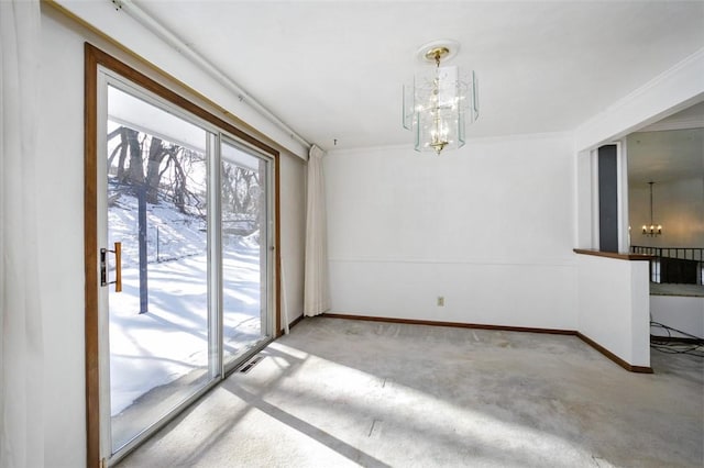 unfurnished dining area featuring ornamental molding, carpet floors, and a notable chandelier