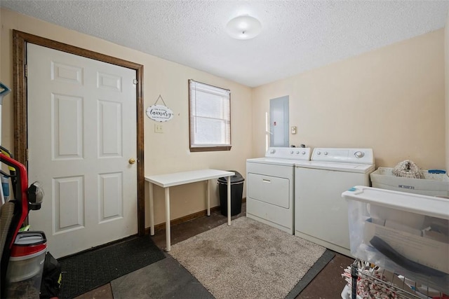 clothes washing area with washer and dryer, sink, electric panel, and a textured ceiling