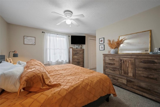 carpeted bedroom featuring ceiling fan and a textured ceiling