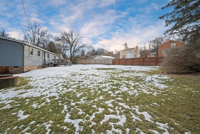 yard layered in snow with a wooden deck