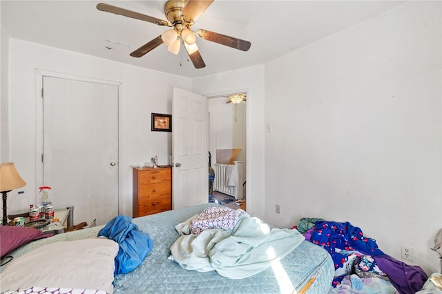 bedroom featuring ceiling fan and radiator heating unit