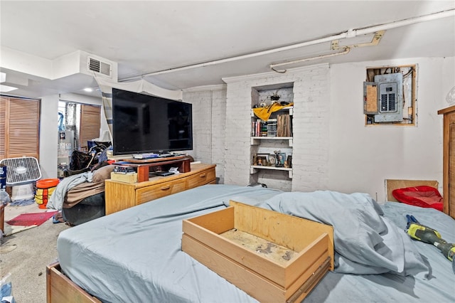 bedroom featuring electric panel and a closet