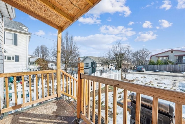 view of snow covered back of property