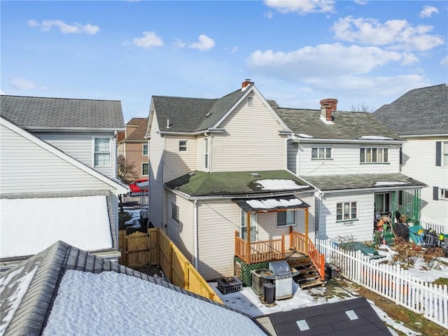 back of house with central AC unit