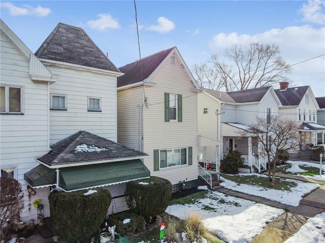 view of snowy exterior featuring a garage