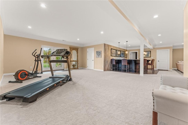 workout area featuring ornamental molding, indoor bar, and light carpet