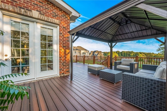 deck with a gazebo, outdoor lounge area, and french doors