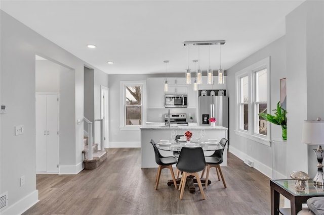 dining room featuring light wood-type flooring and a wealth of natural light