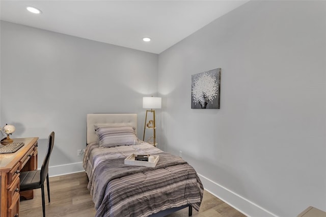 bedroom with hardwood / wood-style floors