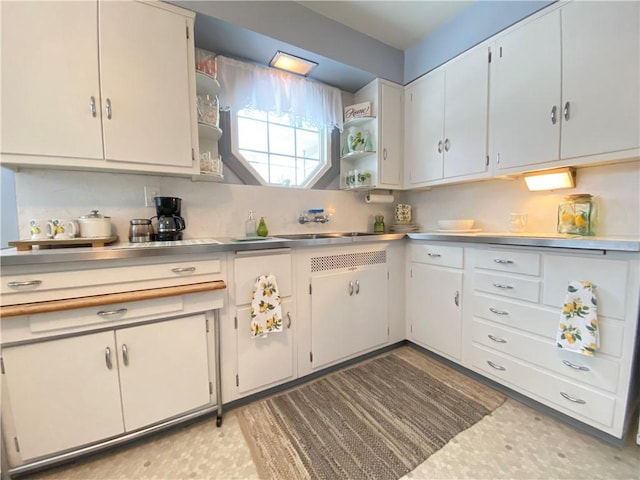 kitchen with white cabinetry and sink