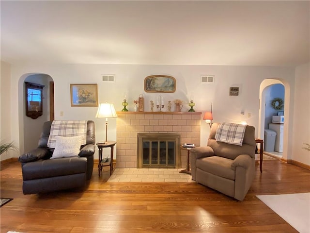 living room with a fireplace and light hardwood / wood-style floors