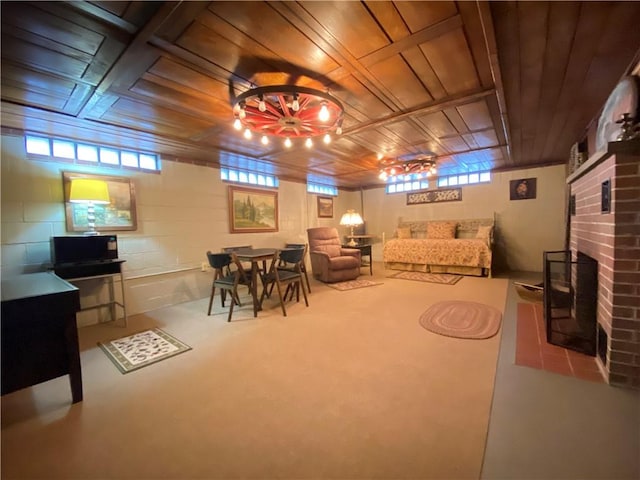 living room with concrete flooring, a brick fireplace, and wood ceiling