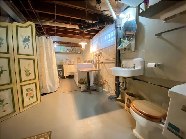 basement featuring washer / clothes dryer and sink