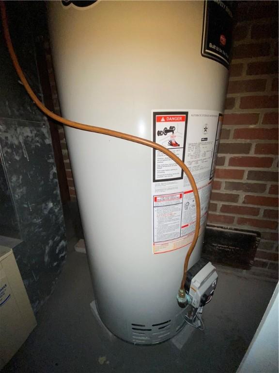 utility room featuring gas water heater