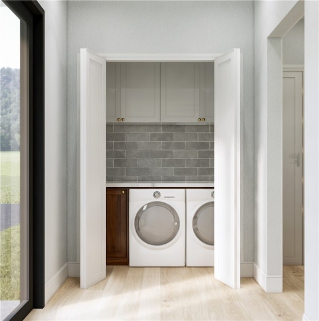 washroom featuring light wood-type flooring and washer and clothes dryer