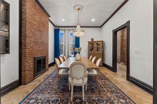 dining space featuring a notable chandelier, a fireplace, ornamental molding, and light parquet floors