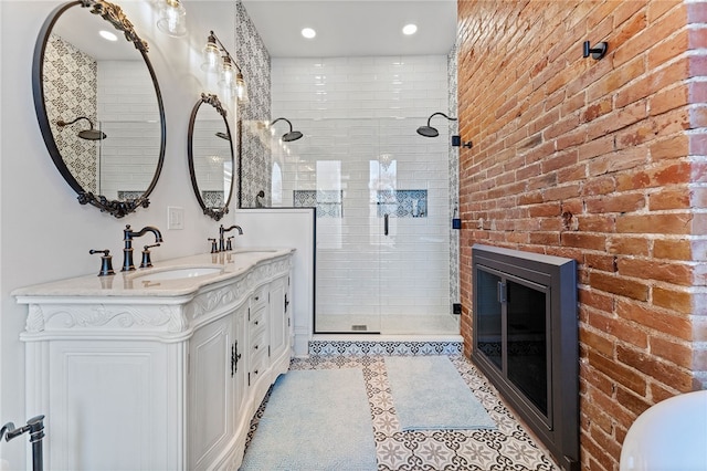 bathroom with tile patterned floors, vanity, a fireplace, and an enclosed shower