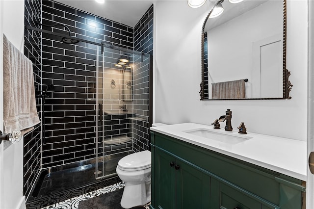 bathroom with a shower with door, vanity, and toilet