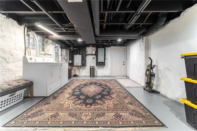 basement with washing machine and dryer and electric panel