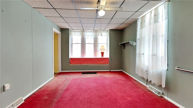 unfurnished room featuring carpet floors, a drop ceiling, and ceiling fan