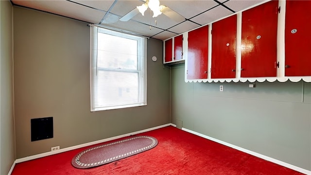 unfurnished room featuring carpet floors, a paneled ceiling, and ceiling fan