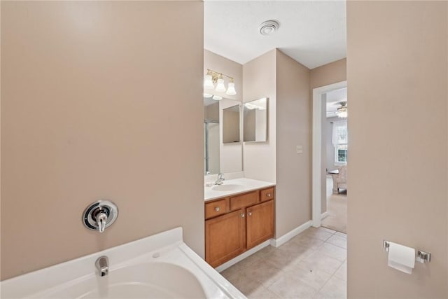 bathroom with tile patterned flooring, vanity, and ceiling fan