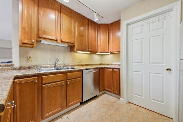 kitchen with sink, light tile patterned floors, track lighting, and dishwasher