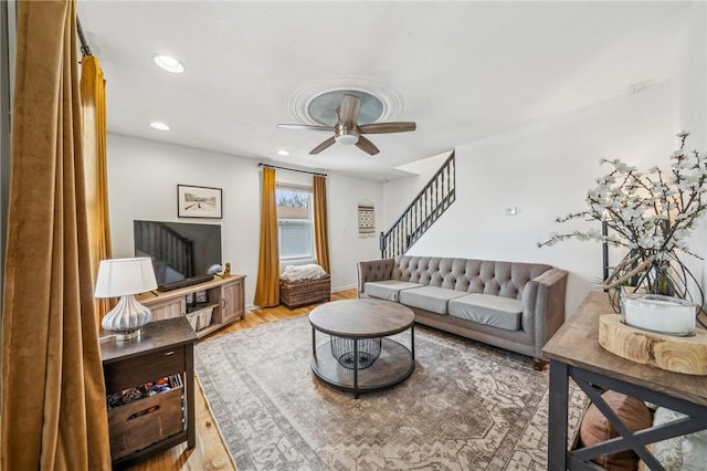 living room featuring ceiling fan and light wood-type flooring