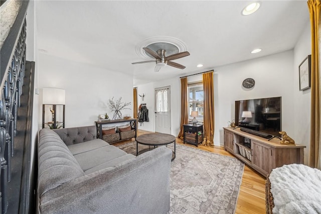 living room featuring ceiling fan and light hardwood / wood-style flooring