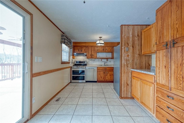 kitchen with sink, extractor fan, light tile patterned floors, stainless steel appliances, and backsplash