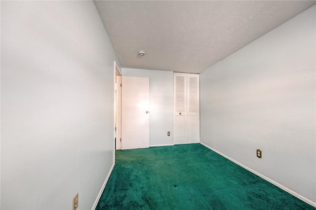 unfurnished bedroom featuring a closet, a textured ceiling, and dark colored carpet