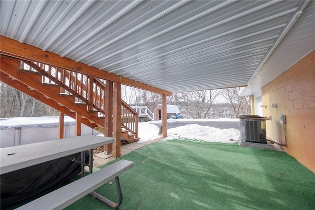 snowy yard featuring central AC unit