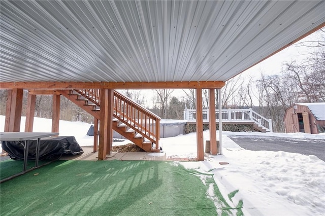 yard covered in snow featuring a storage unit